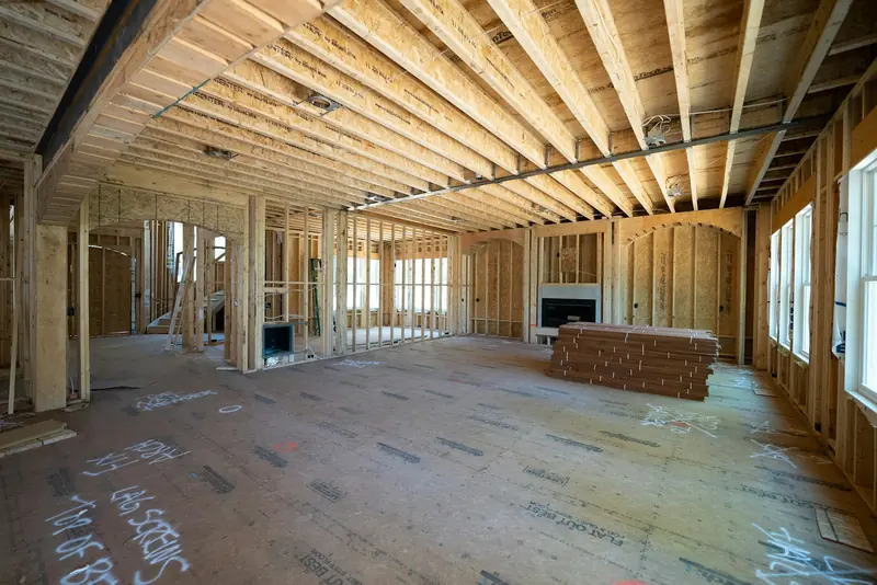 Interior mid-renovation with open framing and subfloor