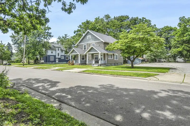 Tree-lined residential street with two-story homes